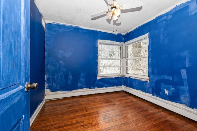 unfurnished room with ceiling fan, crown molding, a baseboard radiator, and dark hardwood / wood-style floors