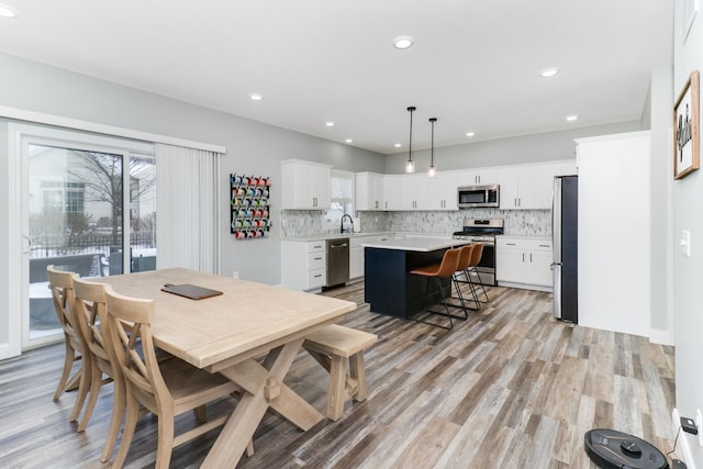 dining space featuring light hardwood / wood-style floors and sink