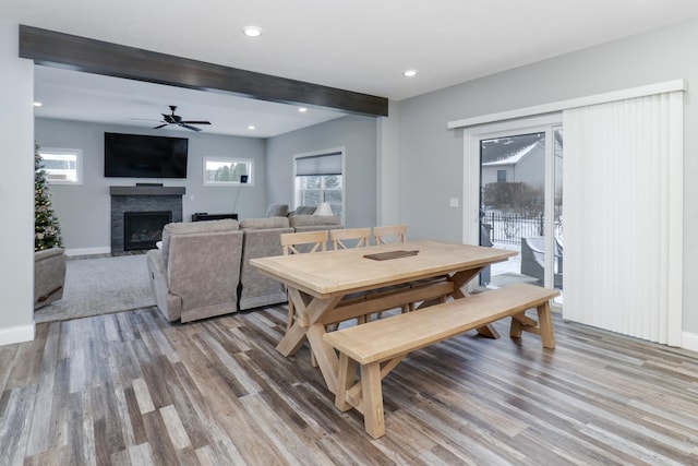 dining room featuring ceiling fan, beam ceiling, and wood-type flooring