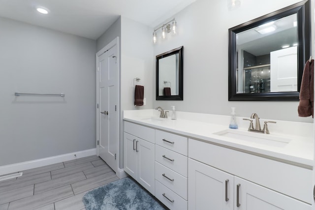 bathroom featuring vanity and a shower with shower door