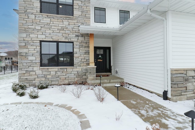 view of snow covered property entrance