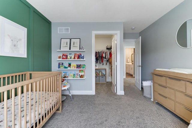 carpeted bedroom with a crib and a closet