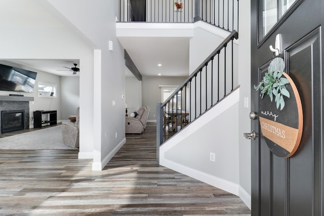 entrance foyer featuring ceiling fan, a high ceiling, and dark hardwood / wood-style floors