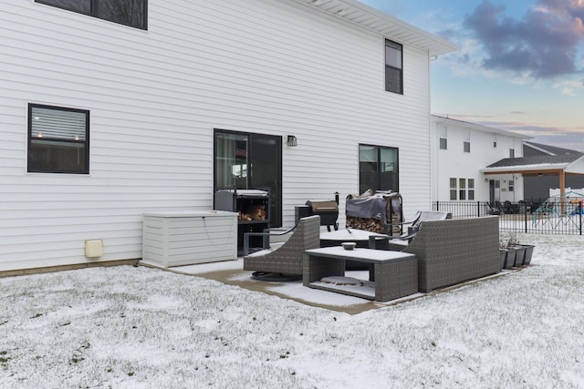 snow covered rear of property featuring an outdoor living space