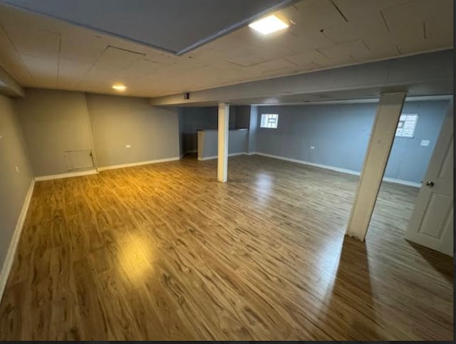 basement with hardwood / wood-style floors