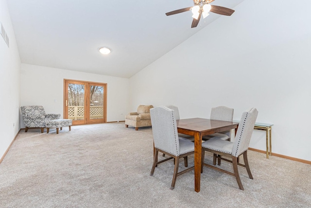 carpeted dining area featuring ceiling fan and high vaulted ceiling