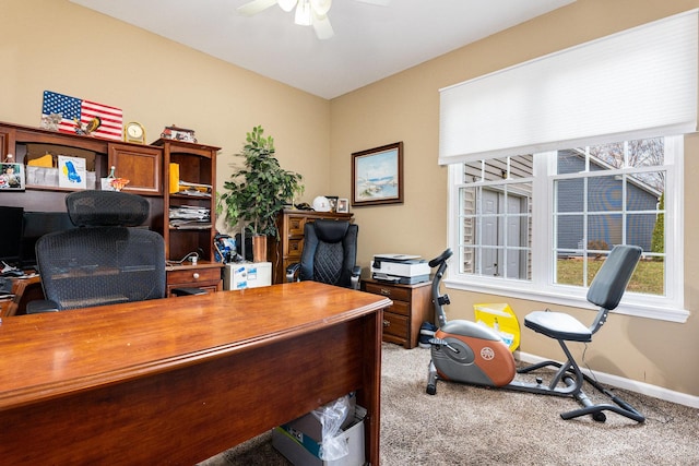 carpeted home office with ceiling fan