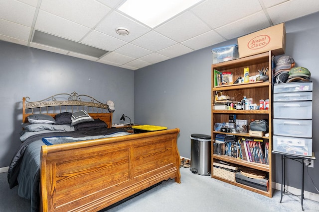 bedroom with a paneled ceiling and carpet flooring