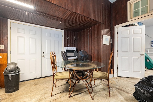 dining area with wooden walls