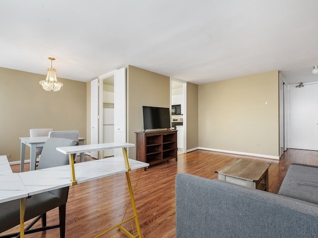 living room featuring a chandelier and hardwood / wood-style floors