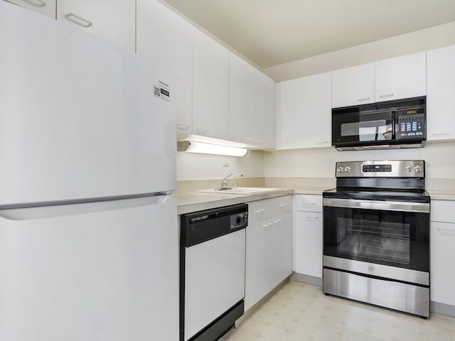 kitchen with white appliances, sink, and white cabinetry