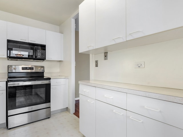 kitchen featuring white cabinets and stainless steel electric range