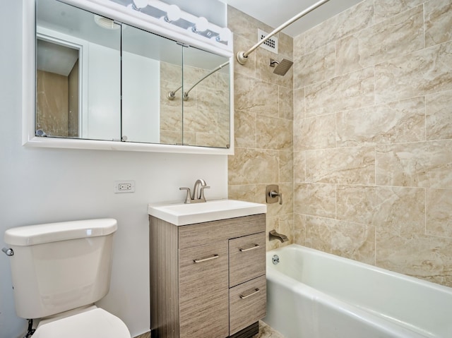 full bathroom with toilet, tiled shower / bath, and vanity