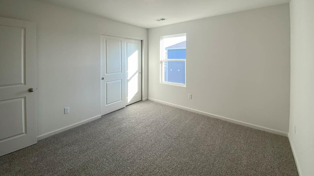 unfurnished bedroom featuring carpet floors and a closet