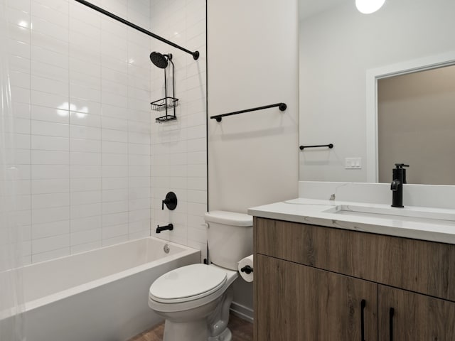 full bathroom with tiled shower / bath, vanity, and toilet