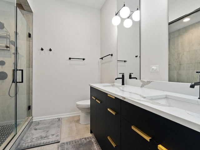 bathroom featuring wood-type flooring, vanity, toilet, and a shower with shower door