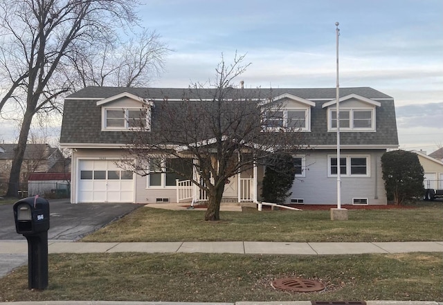 cape cod home with a front yard and a garage