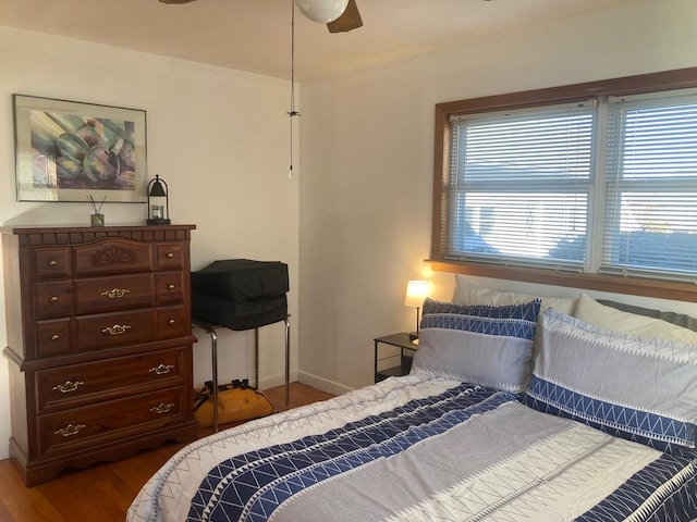 bedroom with ceiling fan and dark wood-type flooring