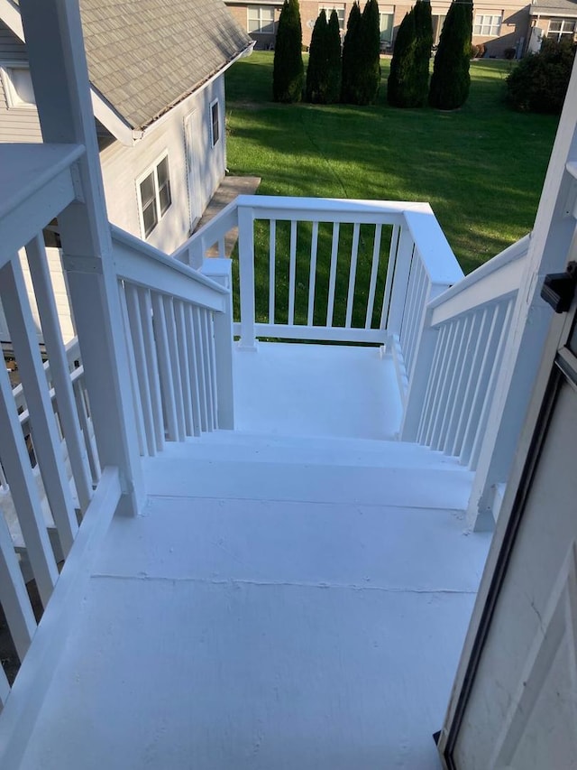 wooden deck featuring a lawn and a porch