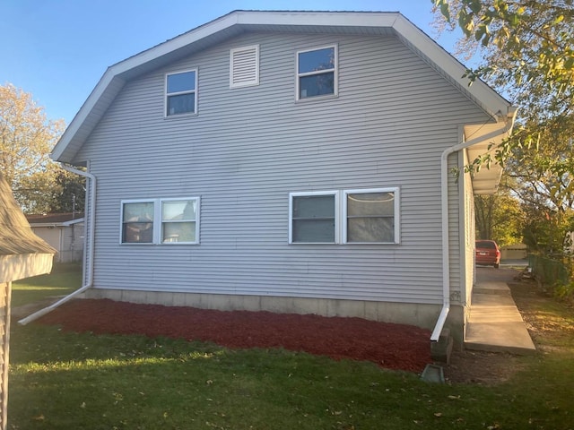 view of home's exterior with a lawn