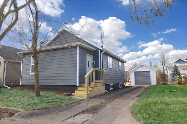 view of front of home featuring an outbuilding, a garage, and a front lawn