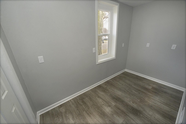 spare room with dark hardwood / wood-style flooring