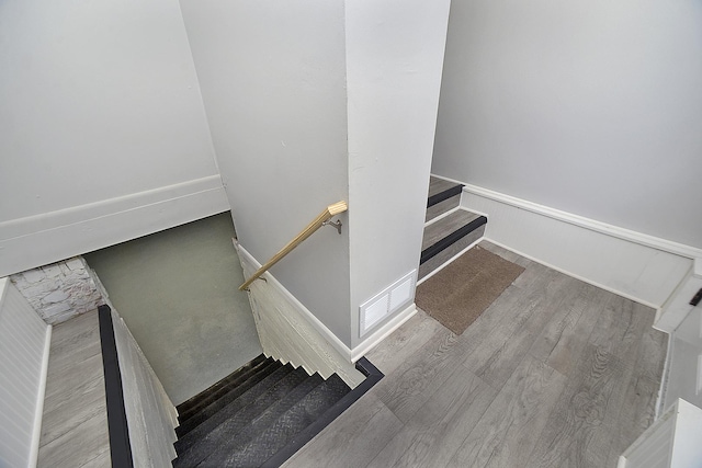 stairway with hardwood / wood-style flooring