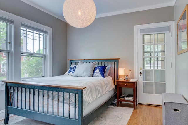 bedroom featuring hardwood / wood-style floors and ornamental molding