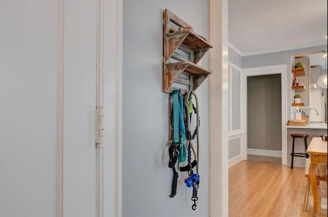 hallway featuring sink and light hardwood / wood-style floors