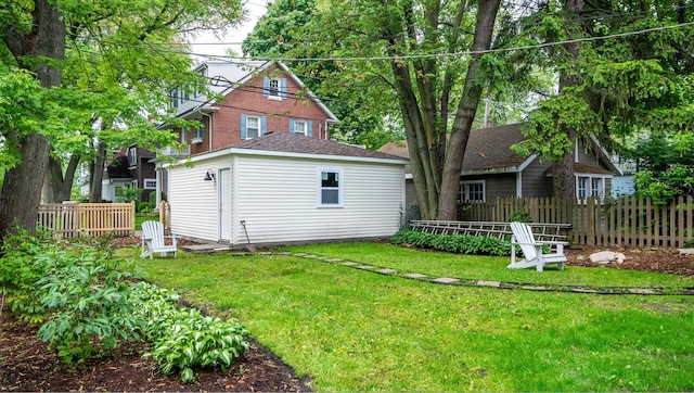 rear view of property with a lawn