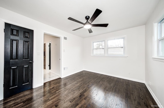 unfurnished bedroom with ceiling fan, dark hardwood / wood-style flooring, and ensuite bathroom