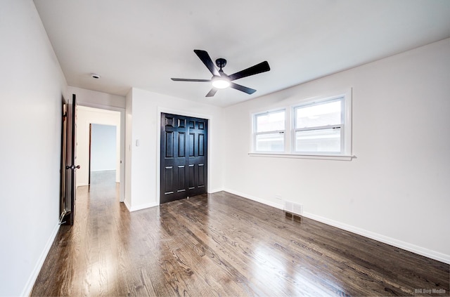 interior space featuring ceiling fan and dark hardwood / wood-style flooring