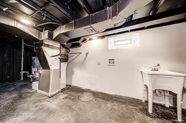 basement with gas water heater and heating unit