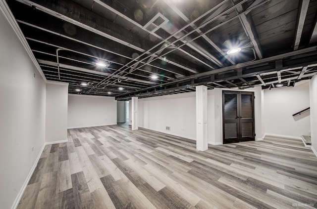 basement with hardwood / wood-style floors