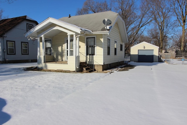 view of front of house featuring a porch, a garage, and an outdoor structure