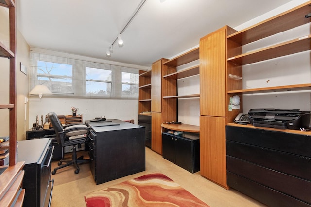 carpeted office space featuring track lighting