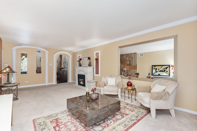 living room with decorative columns, crown molding, and carpet