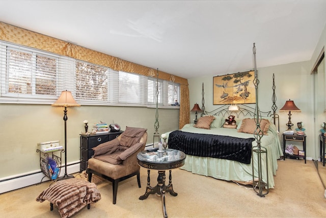 bedroom with carpet, a baseboard heating unit, and multiple windows