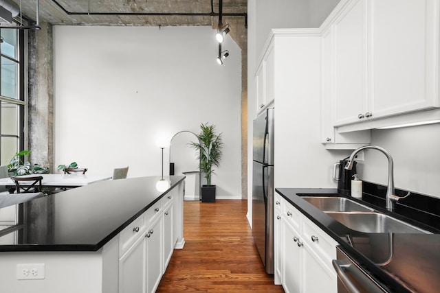 kitchen featuring dark hardwood / wood-style floors, white cabinetry, sink, and appliances with stainless steel finishes