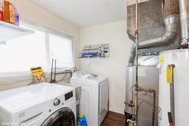 laundry area with dark hardwood / wood-style floors, independent washer and dryer, and water heater