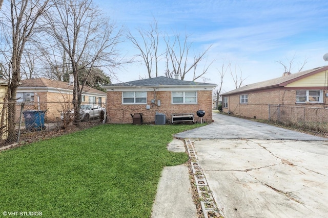 back of property with a lawn and cooling unit