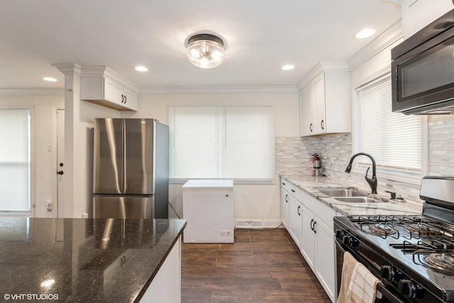 kitchen with dark hardwood / wood-style flooring, tasteful backsplash, sink, black appliances, and white cabinets