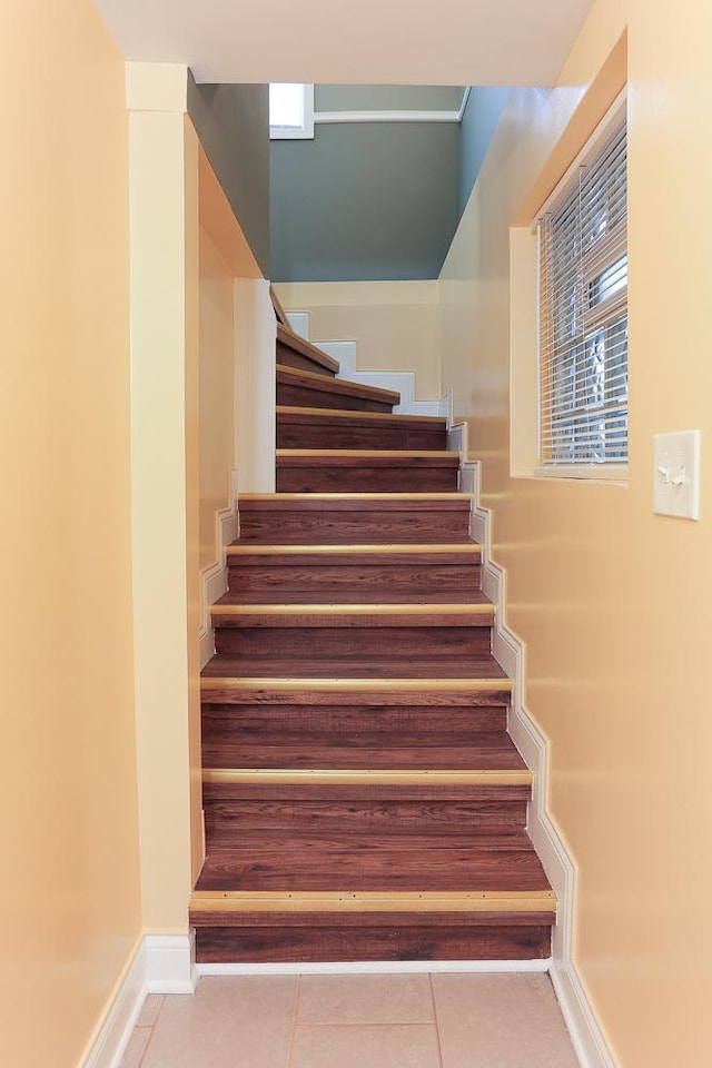 stairs with tile patterned floors