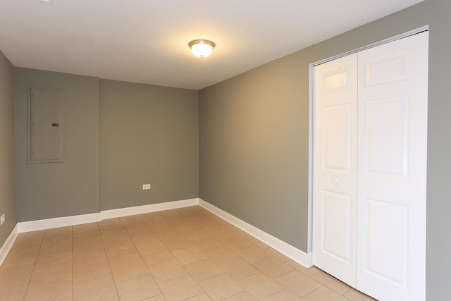 tiled spare room with electric panel