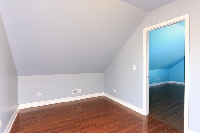 bonus room with dark hardwood / wood-style flooring and lofted ceiling