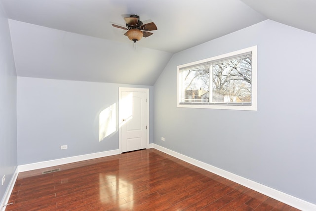 additional living space with dark hardwood / wood-style floors, ceiling fan, and vaulted ceiling