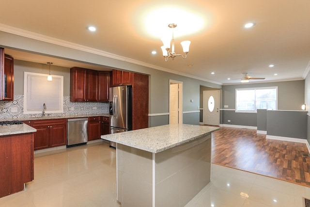 kitchen featuring decorative backsplash, appliances with stainless steel finishes, light hardwood / wood-style flooring, and pendant lighting