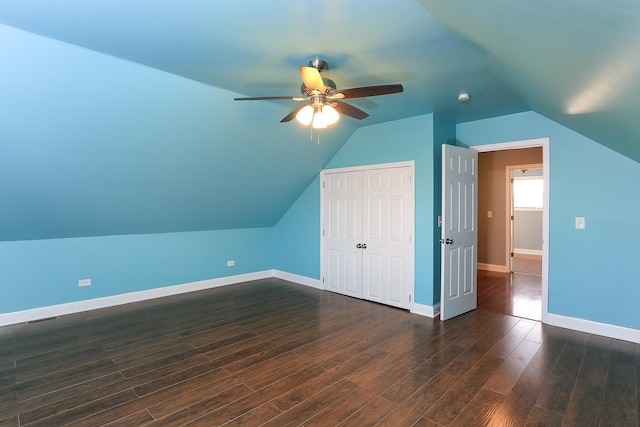 bonus room with ceiling fan, dark wood-type flooring, and vaulted ceiling