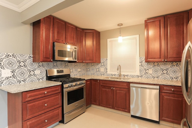 kitchen with decorative backsplash, ornamental molding, stainless steel appliances, sink, and decorative light fixtures