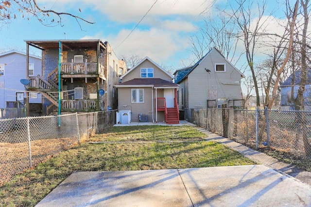 back of property featuring a yard and central air condition unit